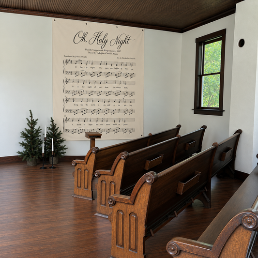 O Holy Night Christmas hymn wall canvas displayed on a church wall above wooden pews.